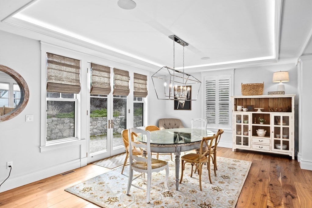 170 Otis Street Hingham, MA 02043 - Photo 7 of 42 a dining room with furniture a chandelier and wooden floor