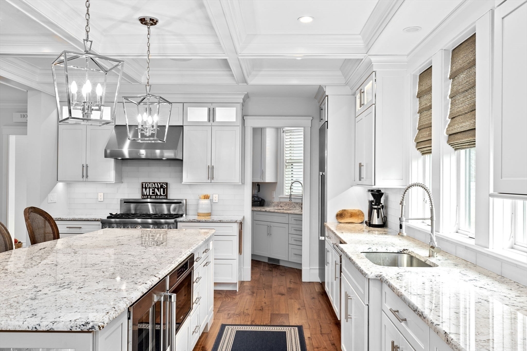 170 Otis Street Hingham, MA 02043 - Photo 10 of 42 a kitchen with stainless steel appliances granite countertop a sink a stove a refrigerator a center island and cabinets