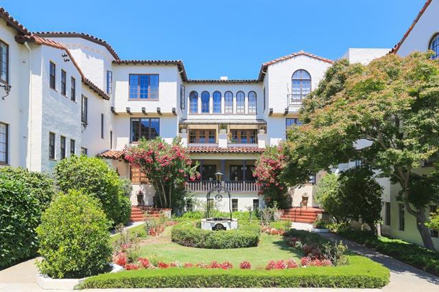 a front view of a residential apartment building with a yard