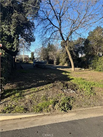 a view of backyard with wooden fence