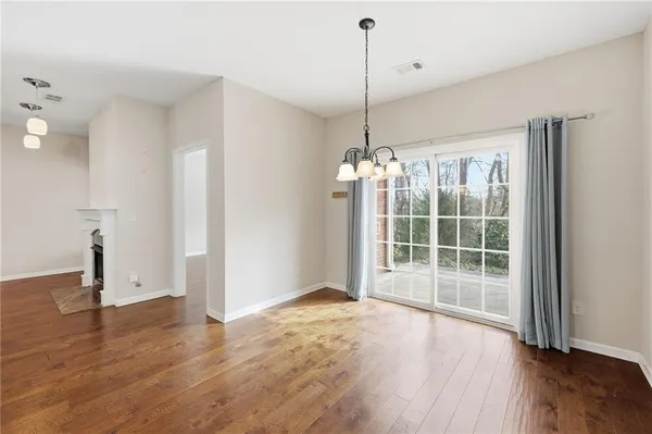 a view of a kitchen with kitchen island white cabinets and stainless steel appliances