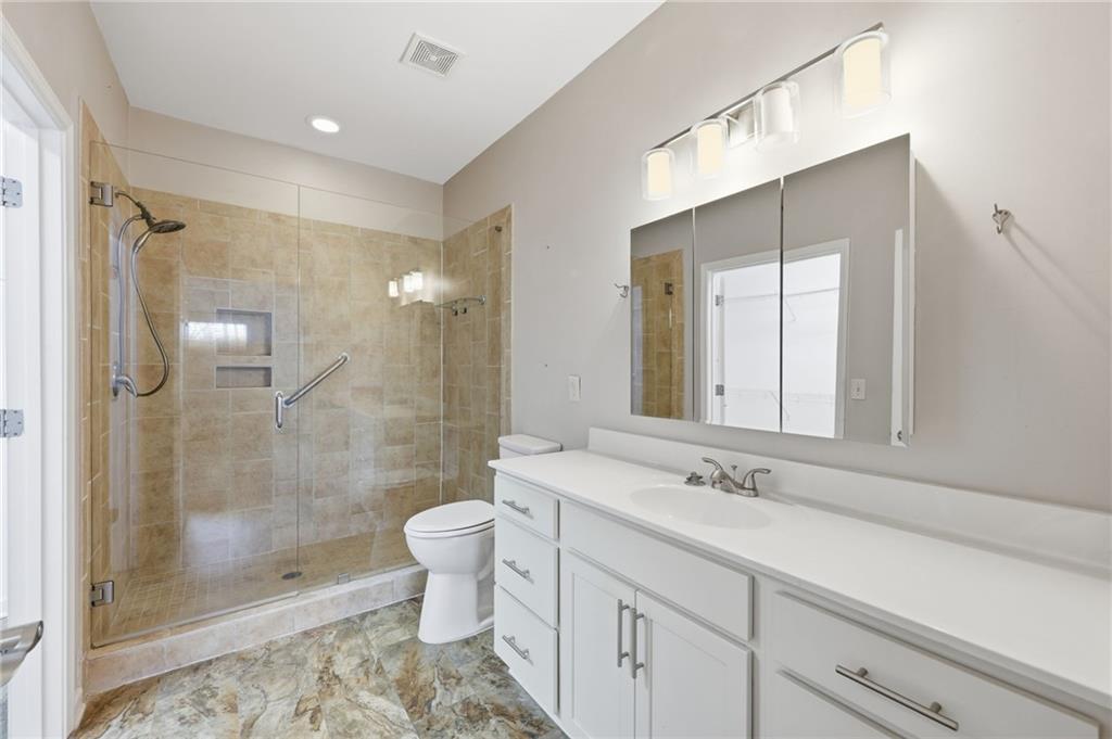 166 Senior Circle Northeast Gainesville, GA 30501 - Photo 20 of 32 a bathroom with a shower sink vanity and toilet