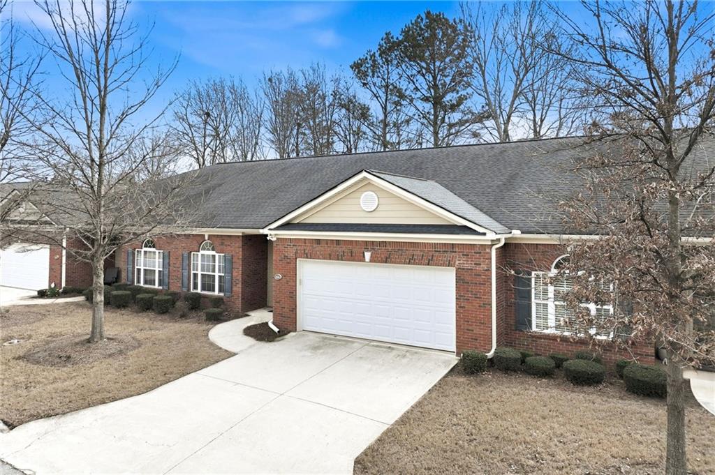 166 Senior Circle Northeast Gainesville, GA 30501 - Photo 2 of 32 a front view of a house with a yard and garage