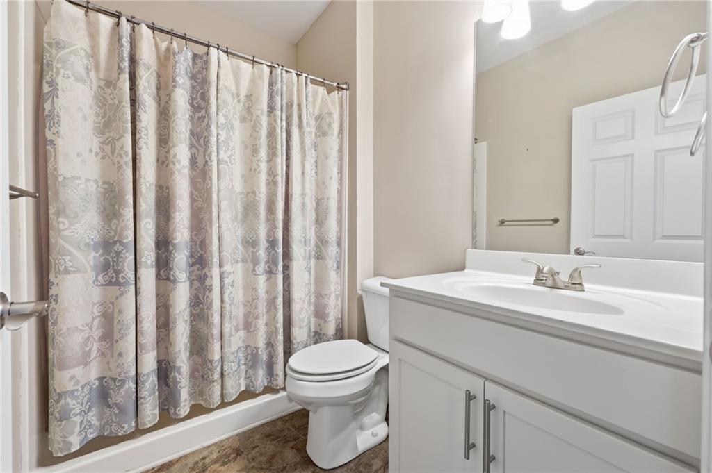 166 Senior Circle Northeast Gainesville, GA 30501 - Photo 24 of 32 a bathroom with a toilet a sink and a mirror