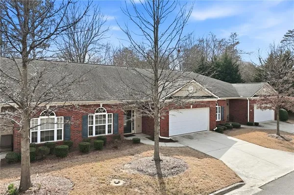 a view of a house with a yard covered in snow