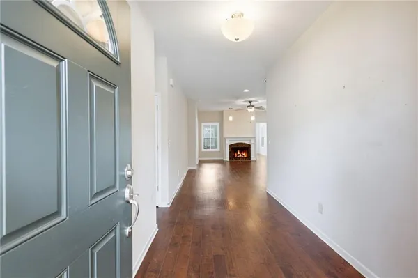 a view of a livingroom with a fireplace a window and a fireplace