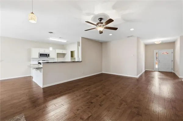 a view of a room with wooden floor and windows