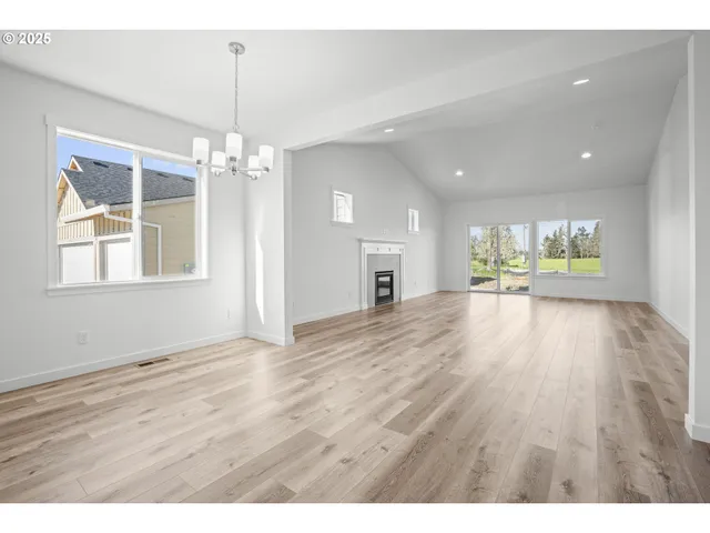 a view of an empty room and wooden floor