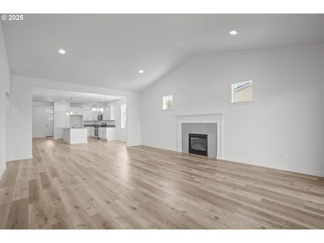 an empty room with fan and windows