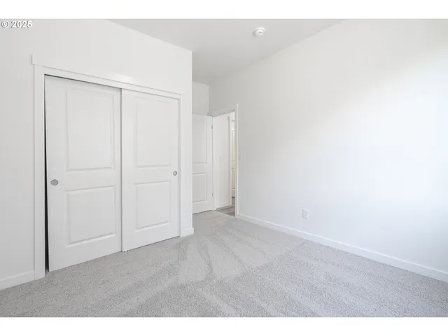 a bathroom with a granite countertop sink toilet a mirror and shower