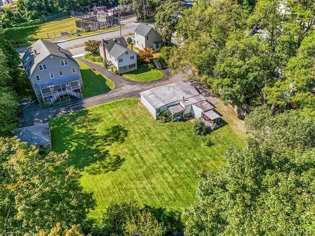 an aerial view of residential house with outdoor space and parking