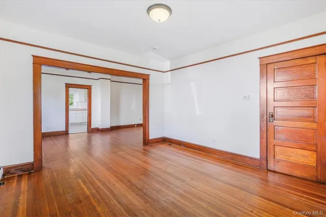 an empty room with wooden floor and closet