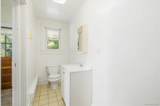a bathroom with a sink toilet and a window