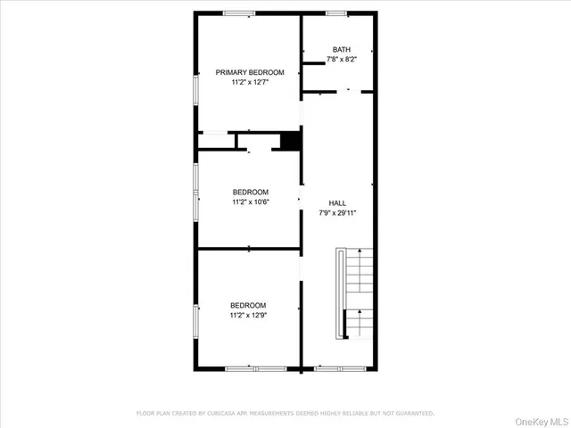 a picture of a bench in front of a wall