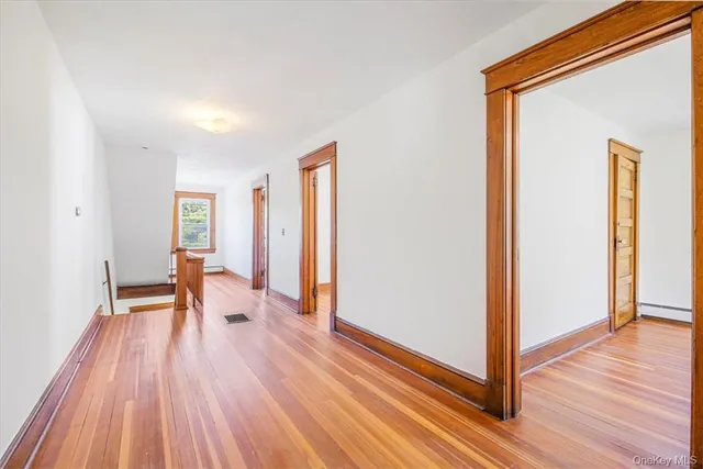 a view of a room with wooden floor lounge chair and windows