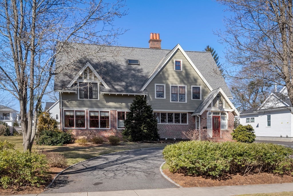 a view of a white house next to a road and yard