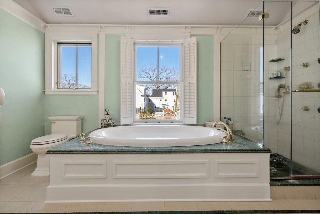 165 Fair Oaks Park Needham, MA 02492 - Photo 17 of 28 a bathroom with a granite countertop sink a mirror and shower