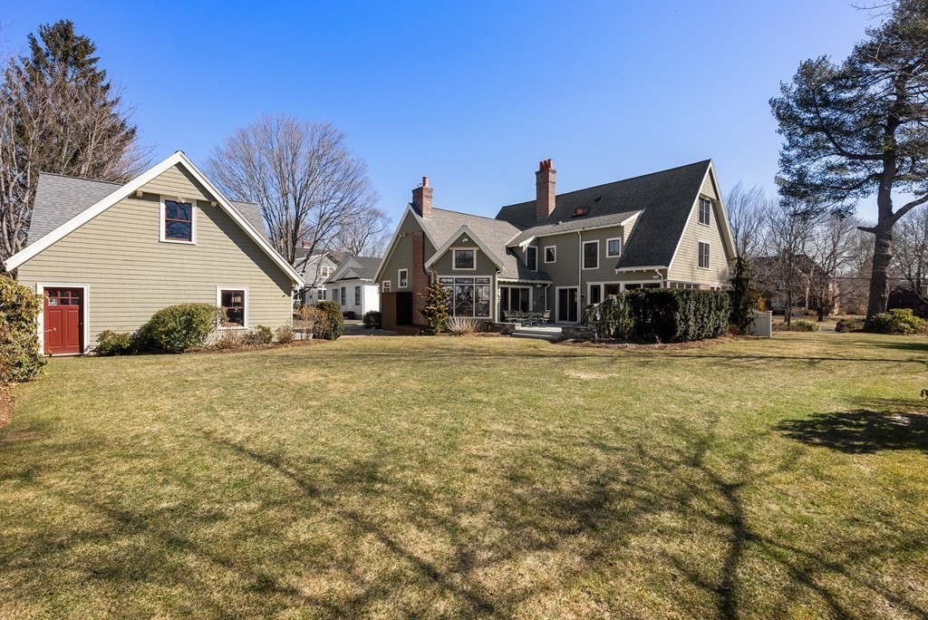 165 Fair Oaks Park Needham, MA 02492 - Photo 25 of 28 a view of a white house with a big yard and large trees