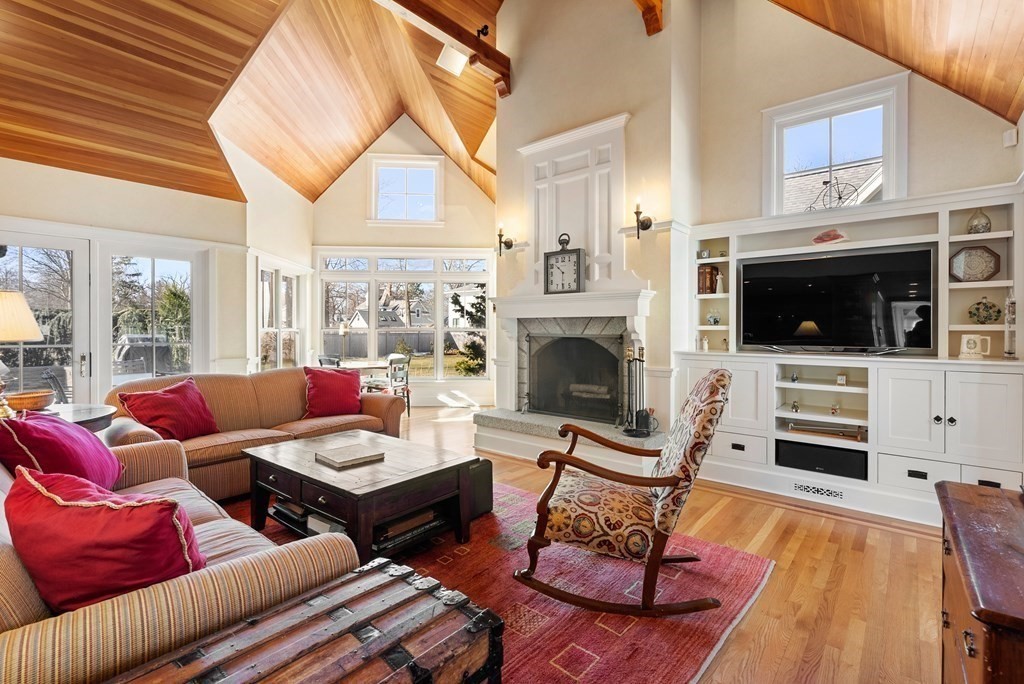 165 Fair Oaks Park Needham, MA 02492 - Photo 3 of 28 a living room with furniture a flat screen tv and a fireplace