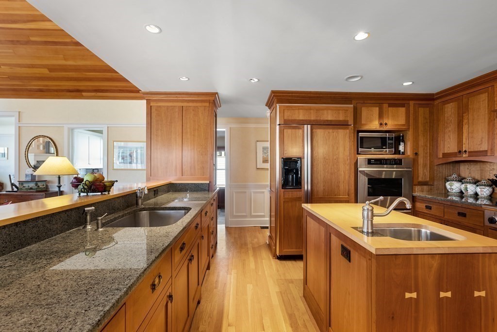 165 Fair Oaks Park Needham, MA 02492 - Photo 6 of 28 a kitchen with granite countertop a sink stove and refrigerator