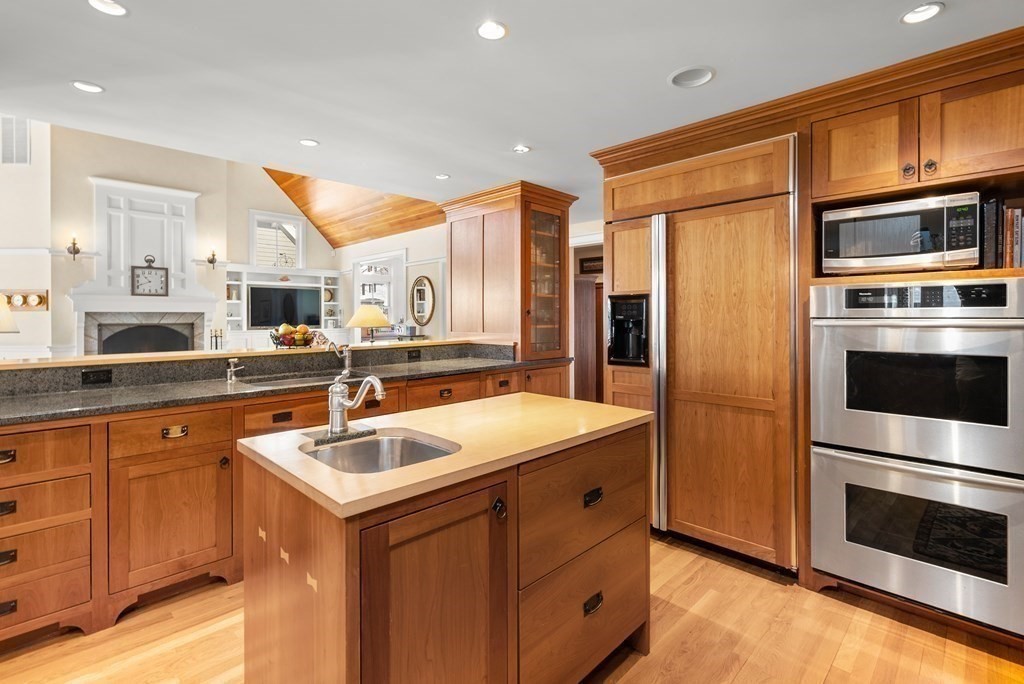 165 Fair Oaks Park Needham, MA 02492 - Photo 9 of 28 a kitchen with stainless steel appliances granite countertop a sink stove and refrigerator