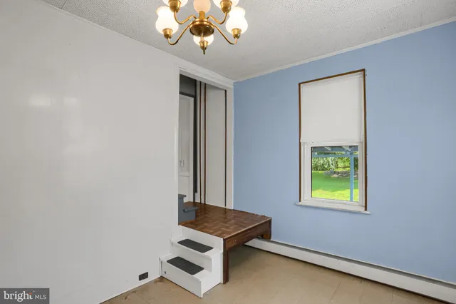 a room with chandelier and window