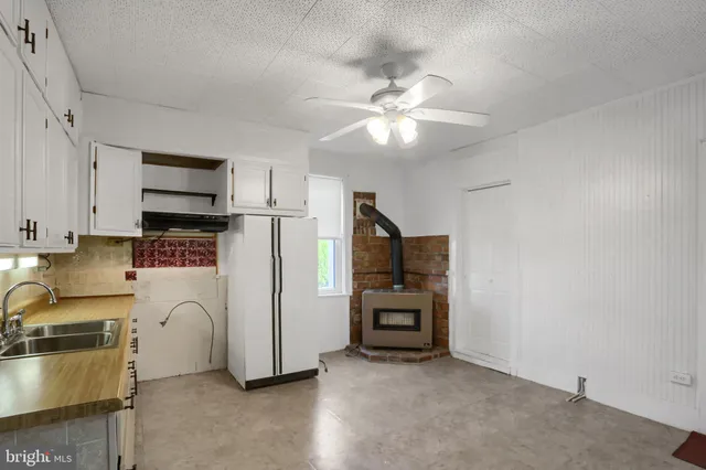 a kitchen with stainless steel appliances a refrigerator and a stove top oven