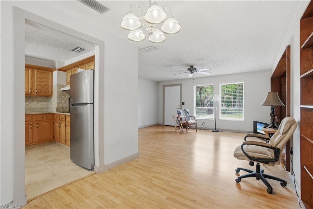 3670 27th Avenue Southwest Naples, FL 34117 - Photo 12 of 38 a view of a livingroom with furniture hardwood floor and a large window