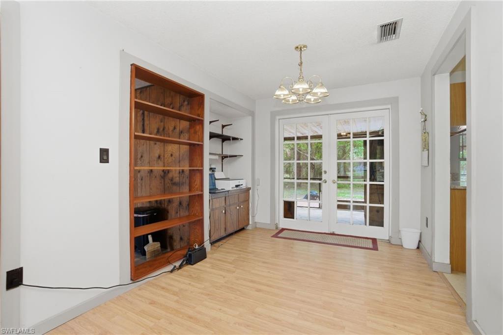 3670 27th Avenue Southwest Naples, FL 34117 - Photo 13 of 38 wooden floor in an empty room with a window
