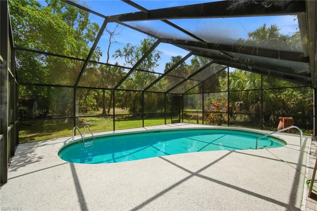 3670 27th Avenue Southwest Naples, FL 34117 - Photo 14 of 38 a view of a swimming pool with a yard