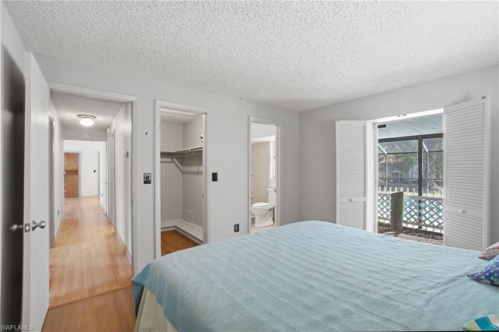 3670 27th Avenue Southwest Naples, FL 34117 - Photo 19 of 38 a bedroom with a bed and a mirror