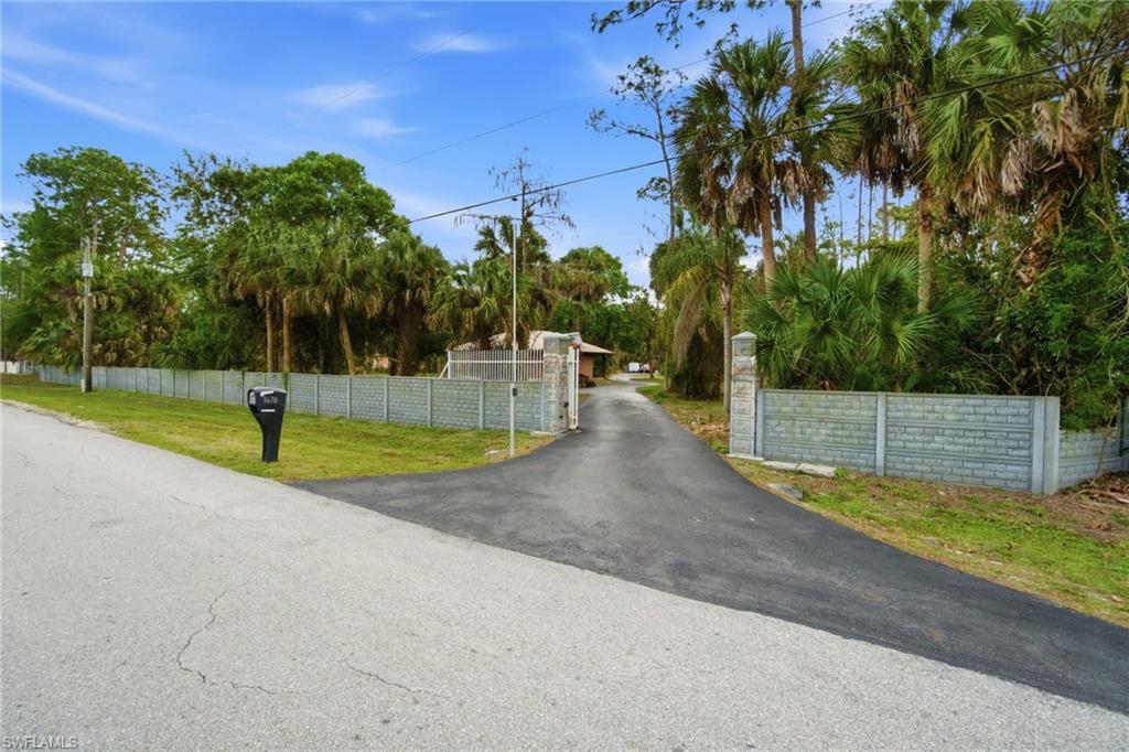 3670 27th Avenue Southwest Naples, FL 34117 - Photo 2 of 38 a view of a swimming pool with a yard
