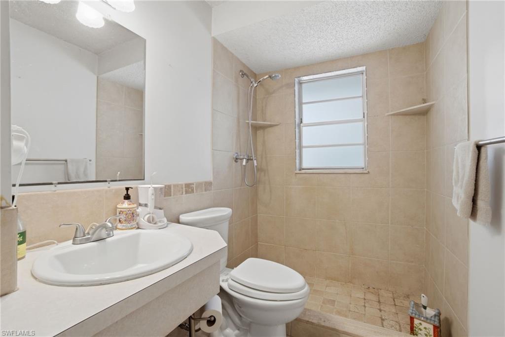 3670 27th Avenue Southwest Naples, FL 34117 - Photo 23 of 38 a bathroom with a sink a toilet and shower