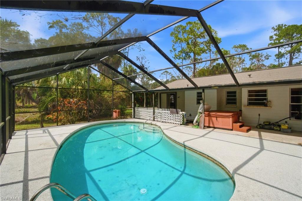 3670 27th Avenue Southwest Naples, FL 34117 - Photo 25 of 38 a view of a swimming pool with a patio and a garden
