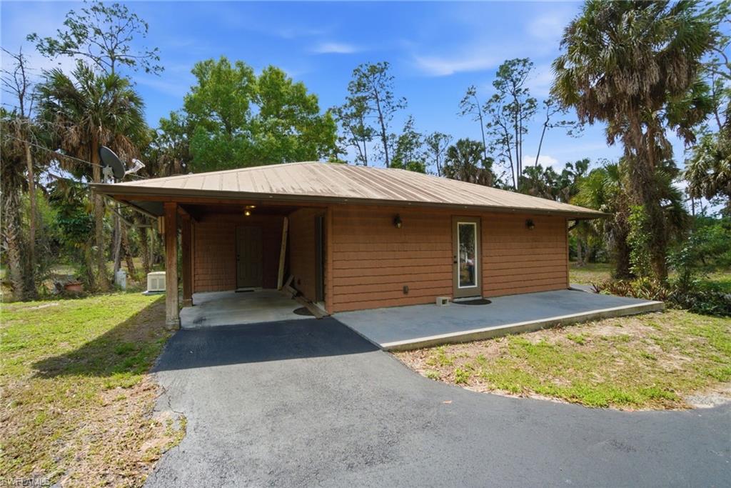 3670 27th Avenue Southwest Naples, FL 34117 - Photo 29 of 38 front view of a house with a yard