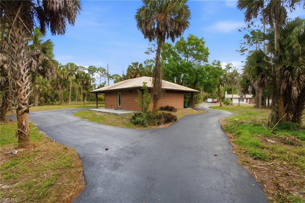 3670 27th Avenue Southwest Naples, FL 34117 - Photo 3 of 38 a view of a house with backyard and trees