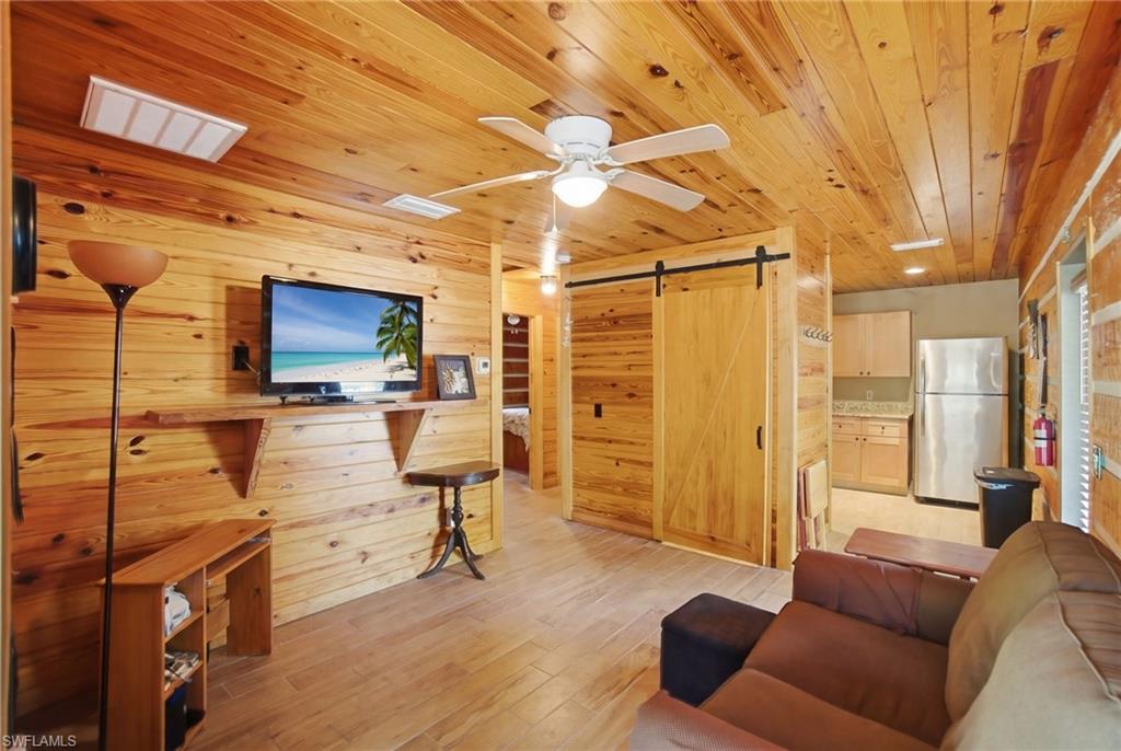 3670 27th Avenue Southwest Naples, FL 34117 - Photo 31 of 38 a living room with furniture and a flat screen tv