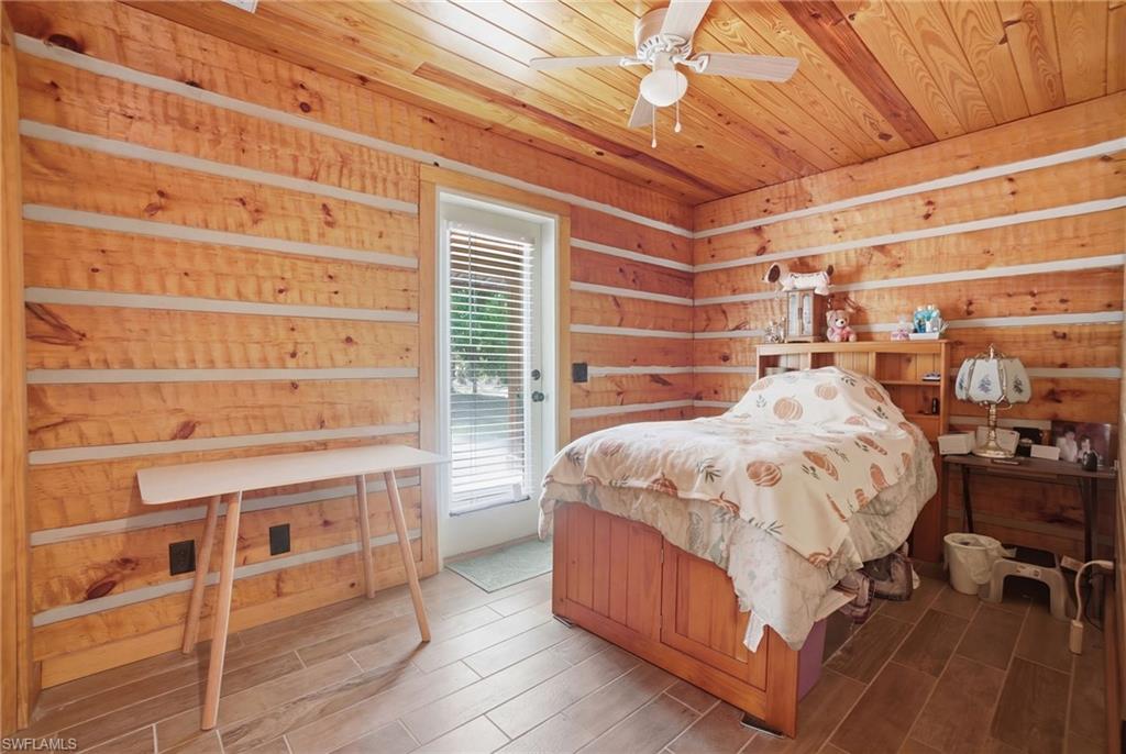 3670 27th Avenue Southwest Naples, FL 34117 - Photo 34 of 38 a bed sitting in a bedroom next to a window