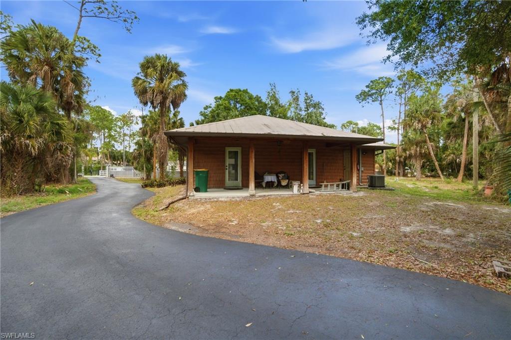 3670 27th Avenue Southwest Naples, FL 34117 - Photo 36 of 38 a front view of a house with a yard