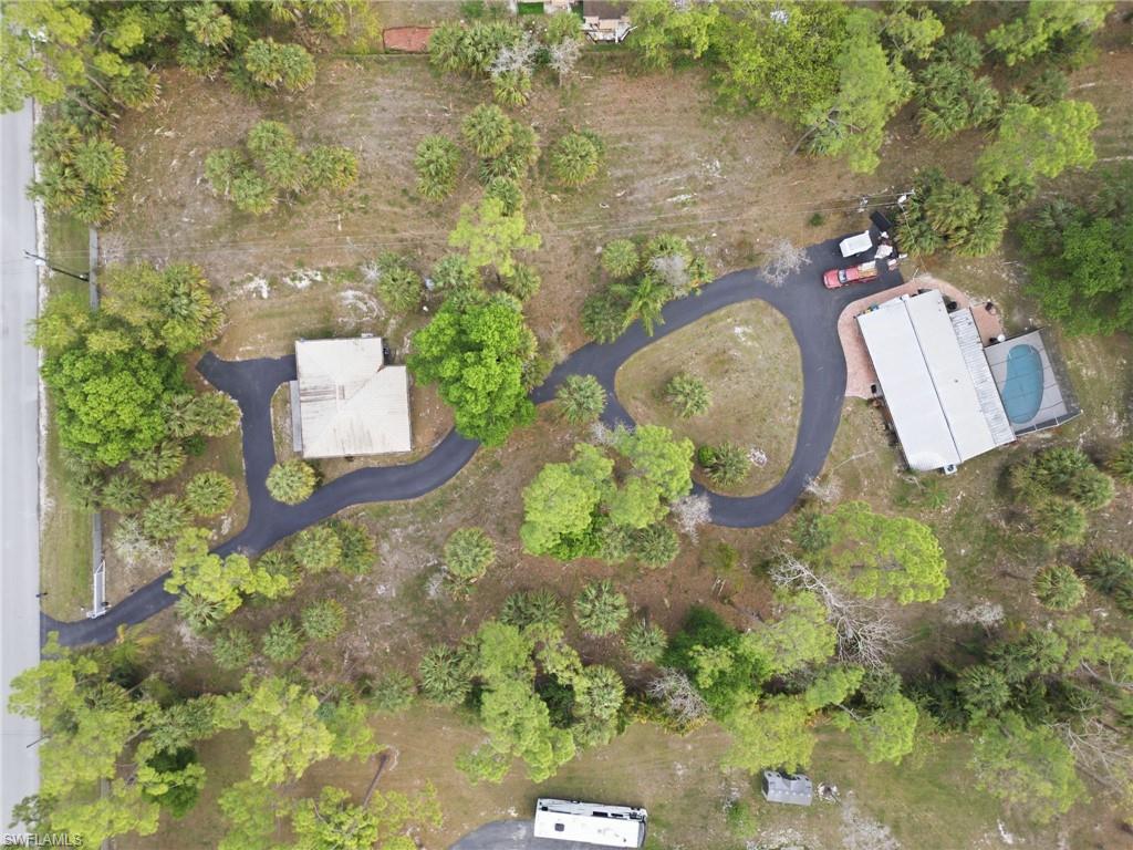 3670 27th Avenue Southwest Naples, FL 34117 - Photo 38 of 38 an aerial view of a house with a yard and trees