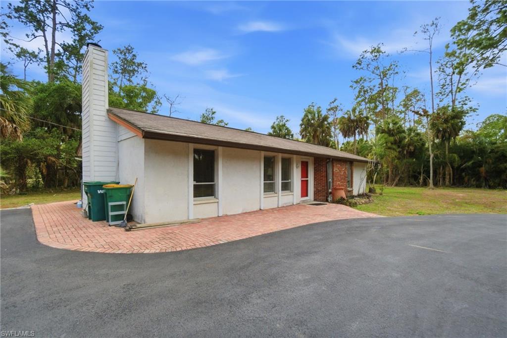 3670 27th Avenue Southwest Naples, FL 34117 - Photo 4 of 38 a view of a house with backyard and trees