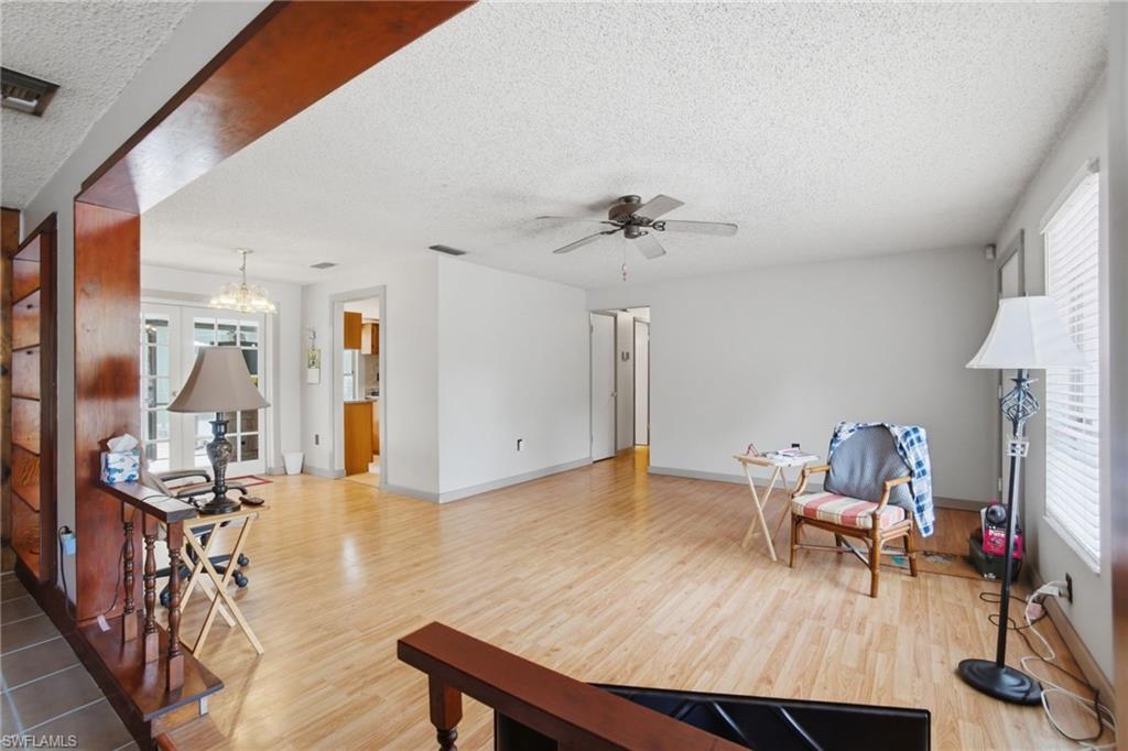 3670 27th Avenue Southwest Naples, FL 34117 - Photo 9 of 38 a living room with furniture and wooden floor