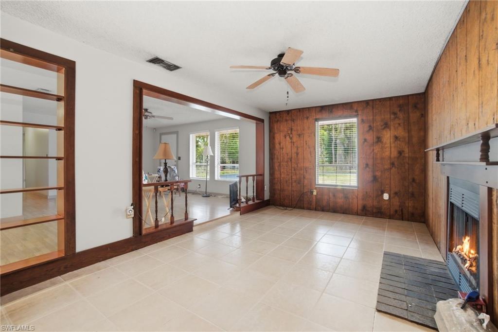 3670 27th Avenue Southwest Naples, FL 34117 - Photo 10 of 38 a view of an empty room with a fireplace and a window