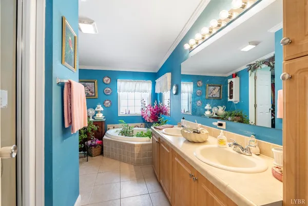 a bathroom with a tub sink and mirror