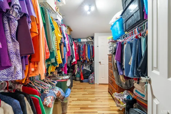 a view of walk in closet with clothes