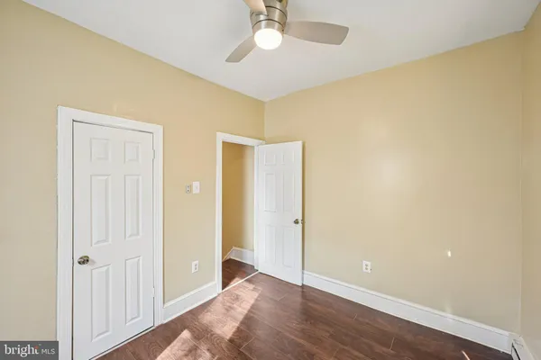 a view of an empty room with wooden floor