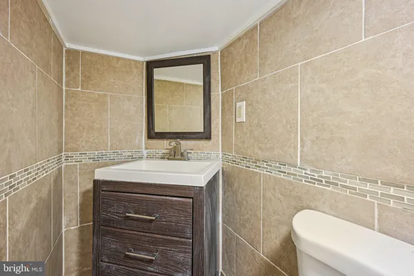 a bathroom with a granite countertop sink a mirror and a bathtub