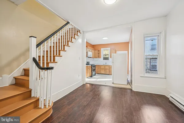 a view of an entryway with wooden floor and door