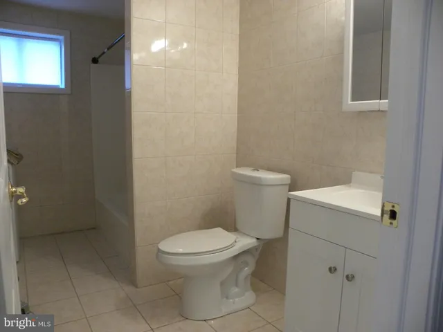 a white toilet sitting next to a bathroom sink