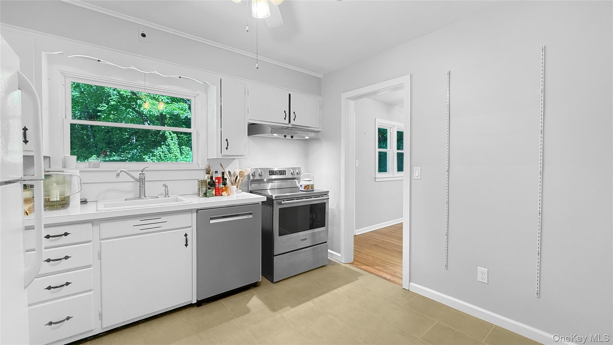 15 Whitehill Place Cold Spring, NY 10516 - Photo 5 of 12 a kitchen with a white stove cabinets and a window